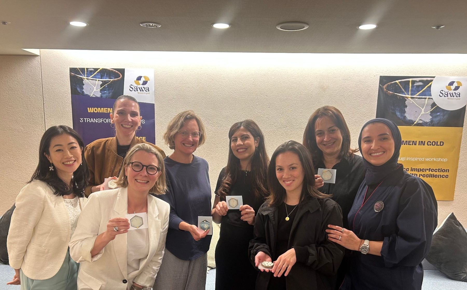 Women in Gold participants holding their finished gold repaired pieces