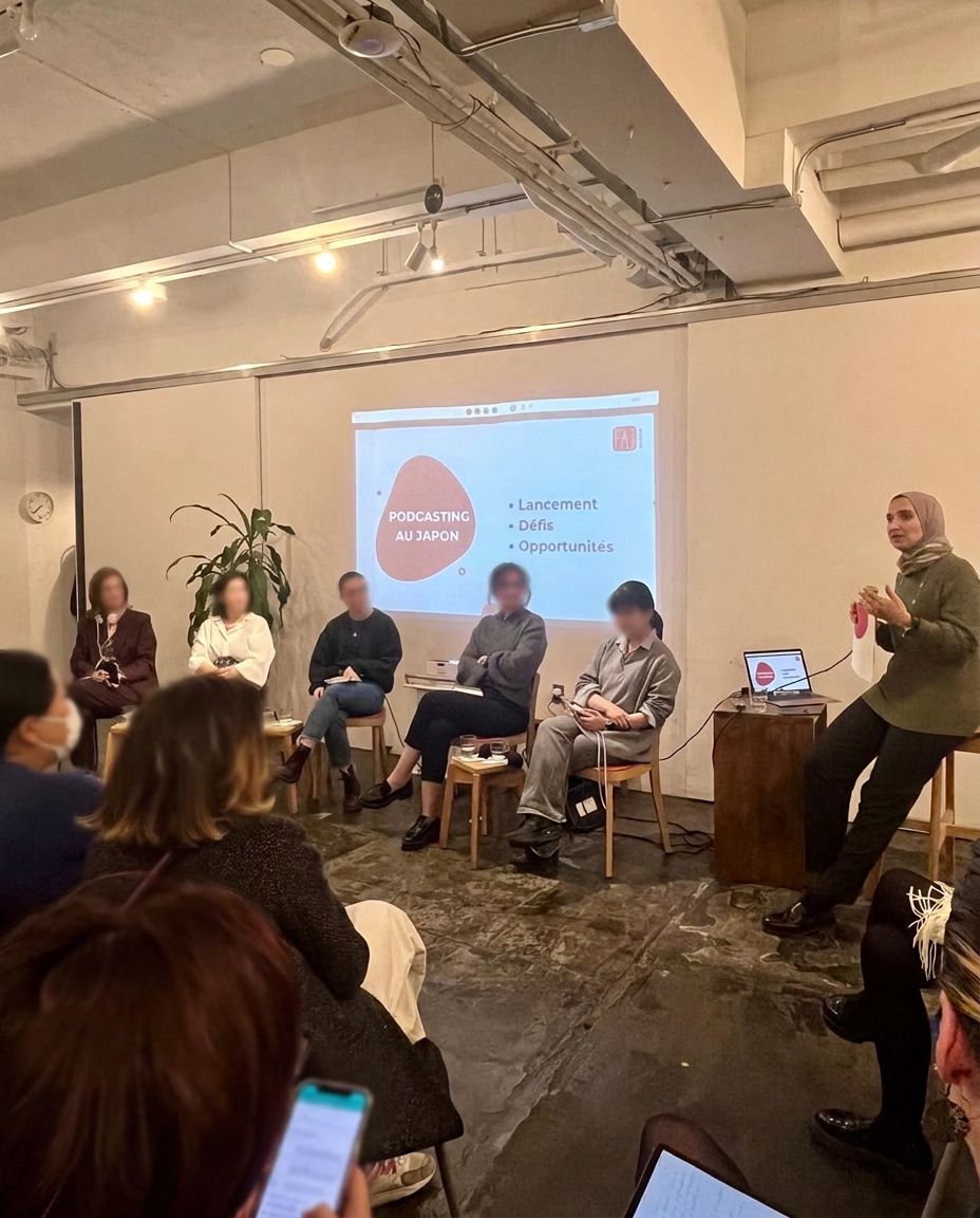 A panel style conversation in a circle with a projected presentation
