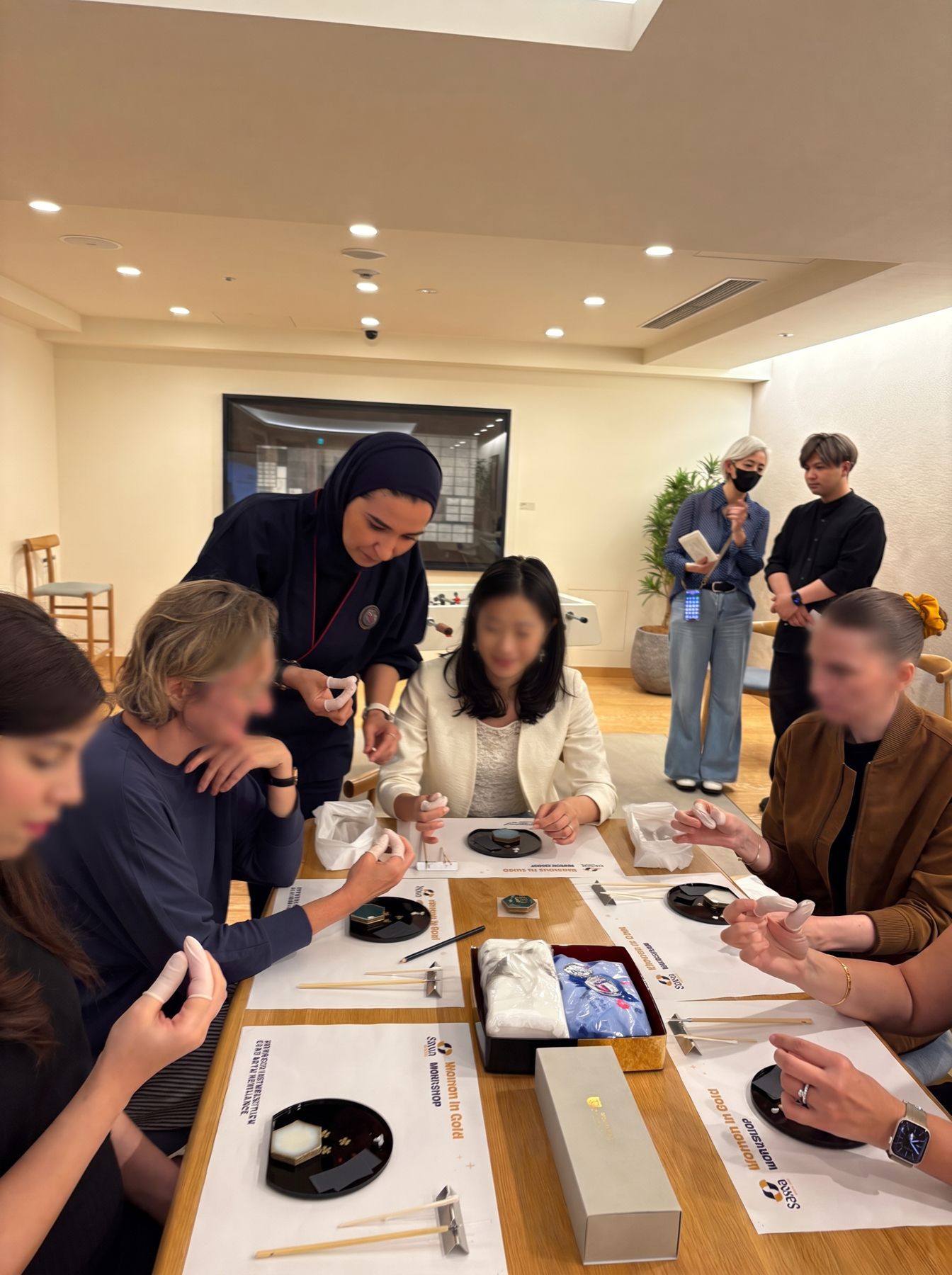 Women practising Kintsugi repair at a workshop table during a Women in Gold session