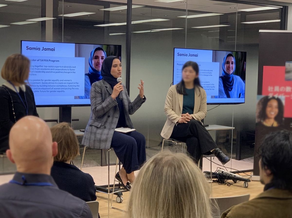 A panel conversation with a microphone in front of a seated audience